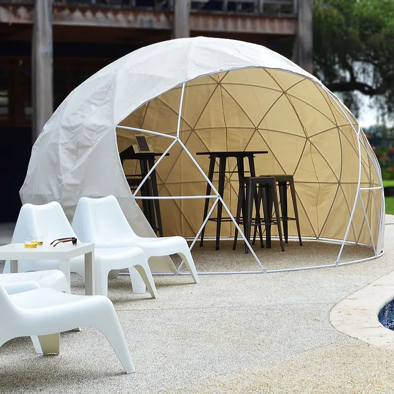 Geodesic Dome Tent with stools and high tables inside, set by a pool, with white outdoor chairs arranged nearby