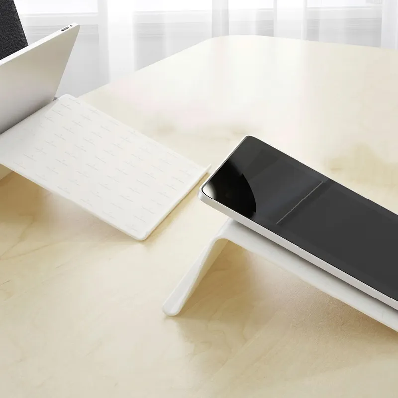 Two tablets on Tablet Stands placed on a light wooden table in a bright, minimalist room